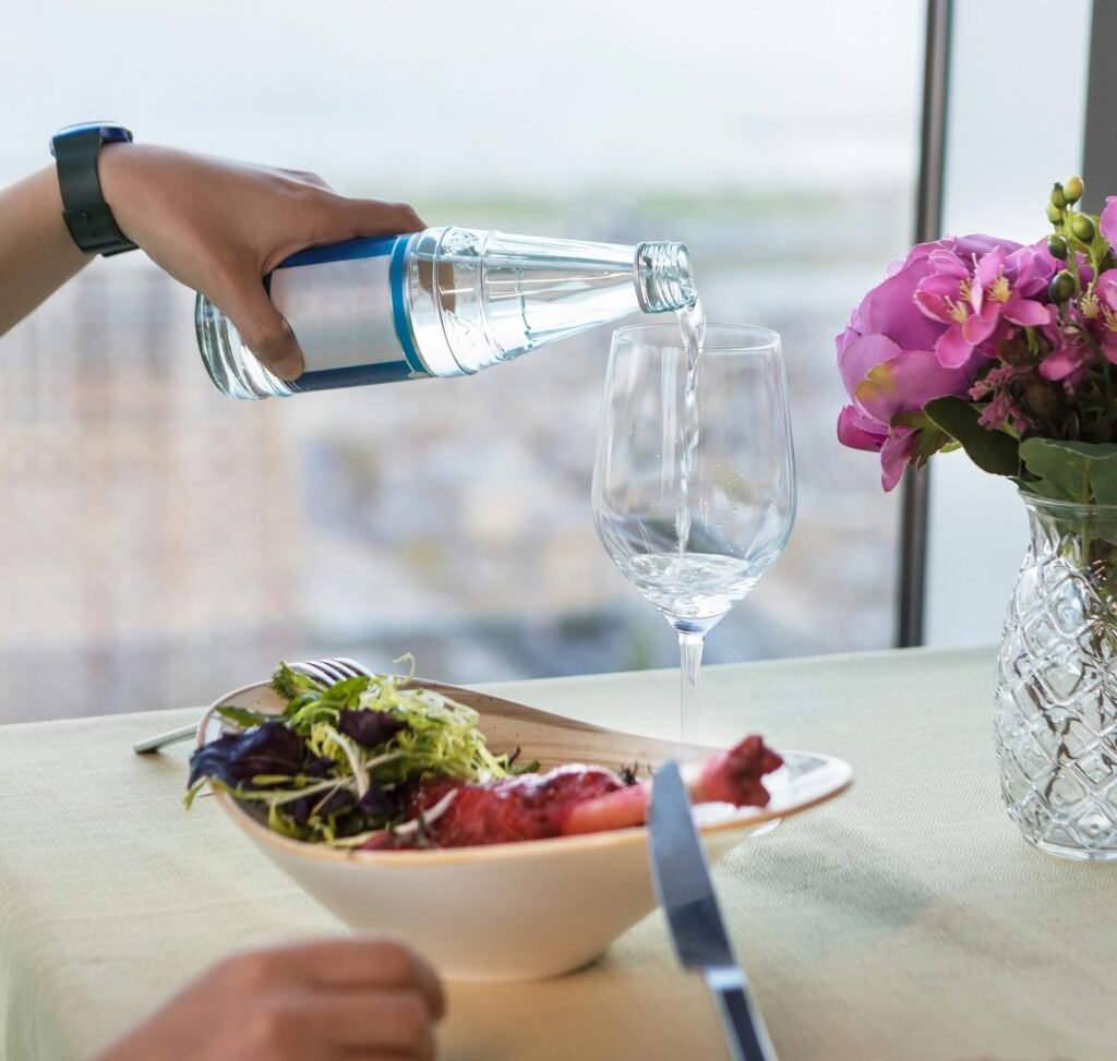 A healthy meal with a glass of water, highlighting the connection between digestion and hydration.